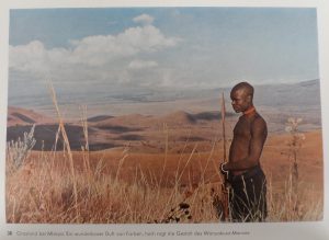 Grasslands in Mbeya [Tanzania]. A wonderful bouquet of colors, the Nyakusa man towers high.