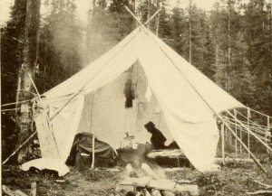 "Mrs. Walcott sketching a wild flower in water colors on a frosty morning in camp."