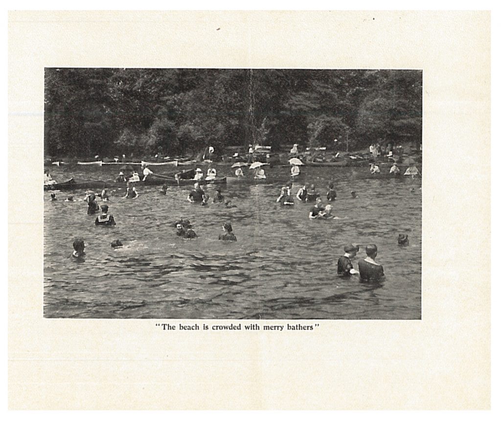 the beach at Lakeside with people swimming and boating