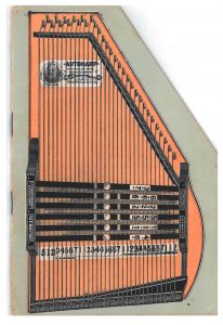 front cover of trade catalog shaped like an autoharp and illustrating an autoharp