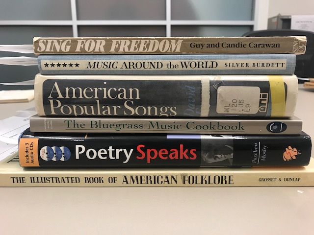 Book spines showing titles for folklore, poetry, music, etc. 