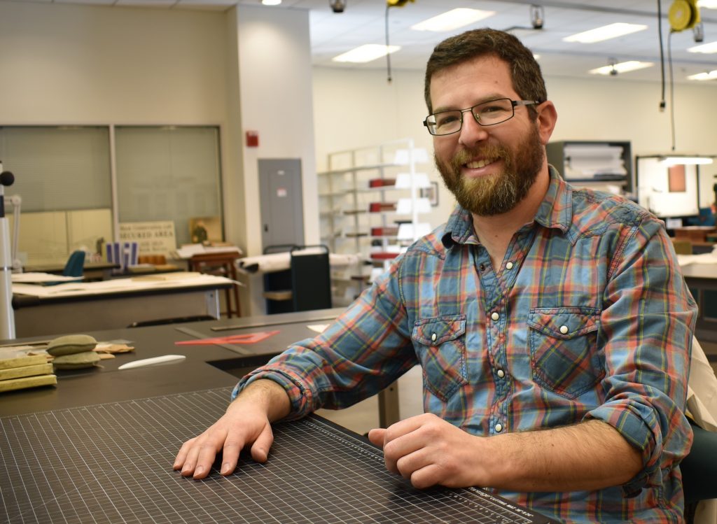 Photo of conservator at bench. 