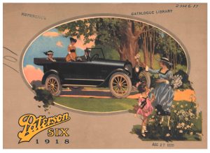 man and two women in a car while a girl and lady pick flowers on the side of the road