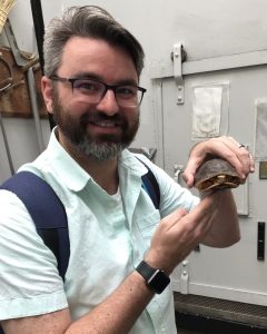 Librarian holding turtle.