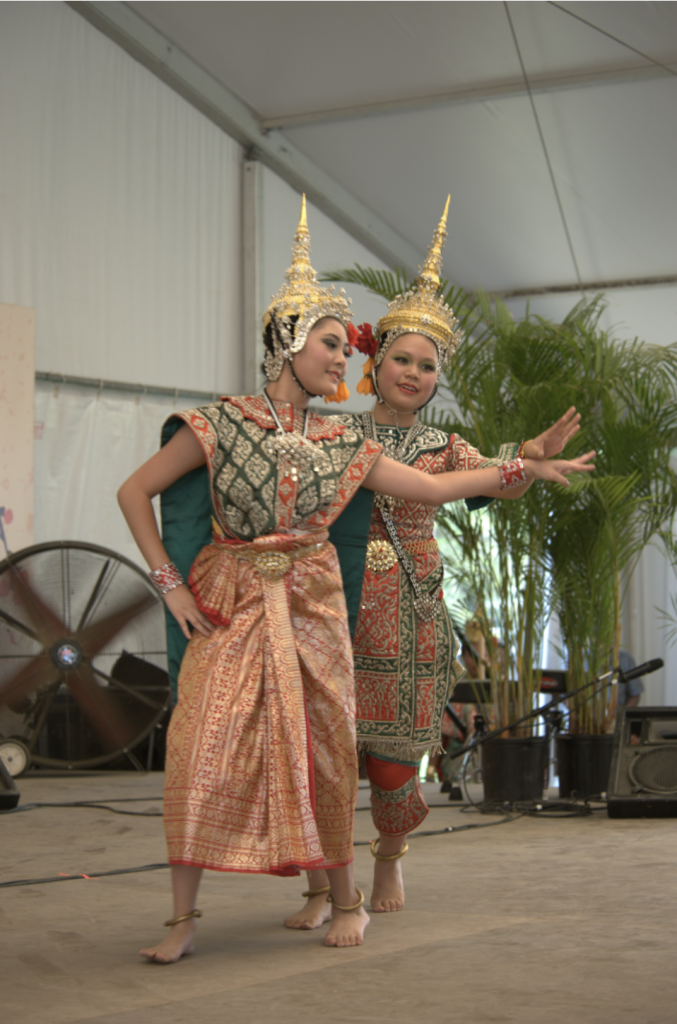 Two dancers in traditional Thai dress.