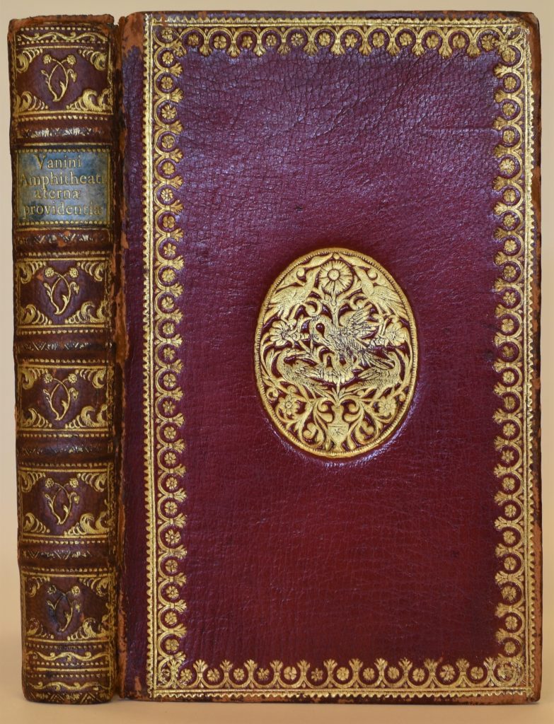 Cover and spine of rare book. Red leather binding with gilded decoration.