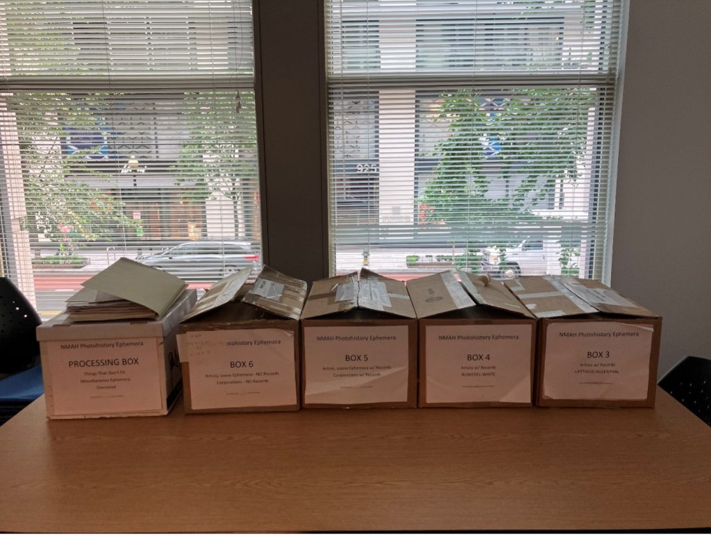 Five cardboard boxes with labels “Box #” on a table.